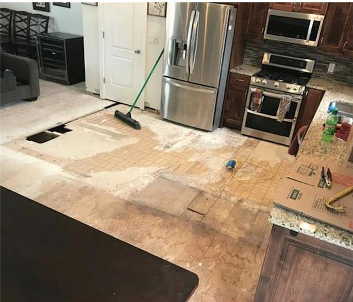 Walls and flooring from kitchen damaged with water damage